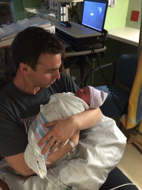 Daddy snuggles in the NICU.