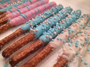 Once the caramel was hardened (after about 3-4 hours, I ended up putting it in the fridge for a half hour to really do the trick), I melted different colored candy melts in a double boiler, dipped my pretzels and covered with sprinkles.