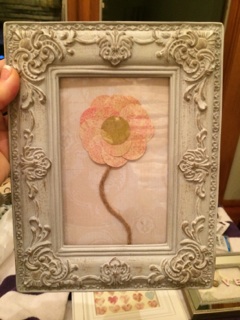Scrapbook paper flower with a hemp stem.