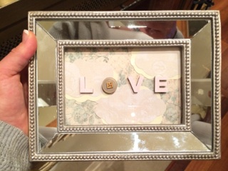 The mirror frame and bad lighting make this one hard to see. But, I just used scrapbook paper inside the frame and painted letters/a button glued on top of the glass to give this one a little dimension and added interest.