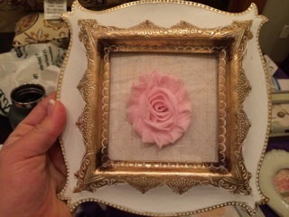This was my last one... creativity was running thin, and I was already wounded from the hot glue gun. So, this one is just scrapbook paper inside the frame and a fabric flower glued to the outside of the glass.